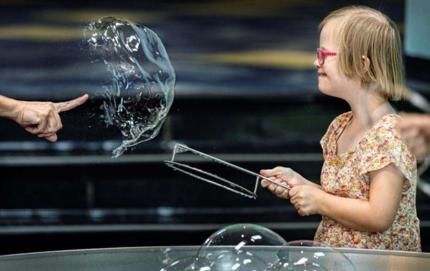 Child playing with bubbles